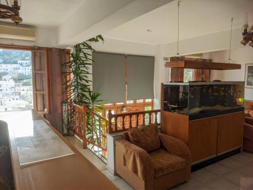 a living room with a fish tank and a couch at Κastro Ηotel in Agios Kirykos