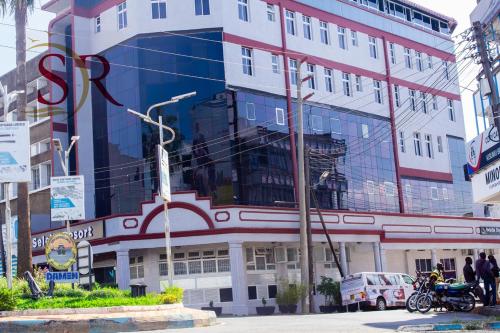 a large building with people standing in front of it at Selella Resort in Kisumu