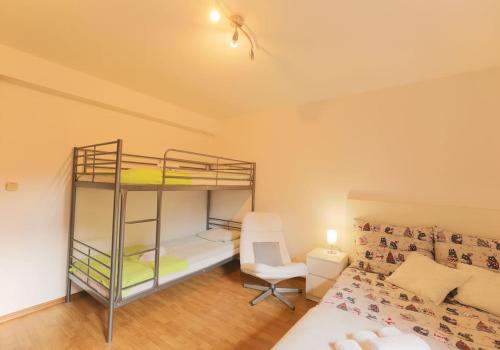 a bedroom with two bunk beds and a couch at Pegaz 3 in Sopot