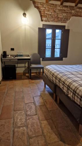 a bedroom with a bed and a table and a desk at Bed & Breakfast 1906 in San Martino In Strada