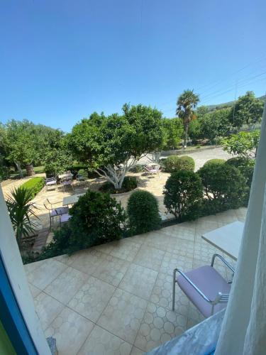 a view of a patio with tables and chairs at Hotel Dini in Vlorë