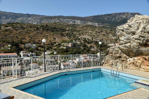 a swimming pool with a view of a mountain at Κastro Ηotel in Agios Kirykos