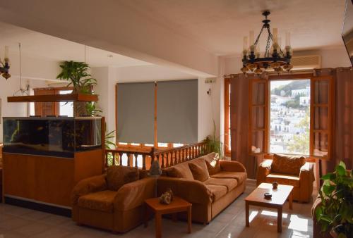 a living room with a couch and a fish tank at Κastro Ηotel in Agios Kirykos