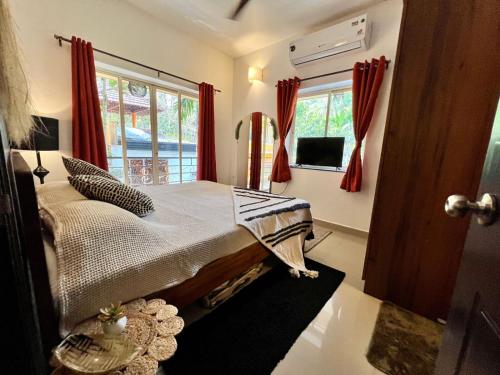 a bedroom with a large bed with red curtains at The Olive Nest in Verla