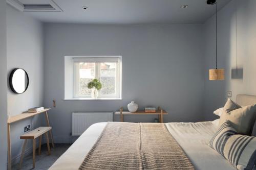 a bedroom with a bed and a window at St Catherine's Hospital - Curated Property in Bath