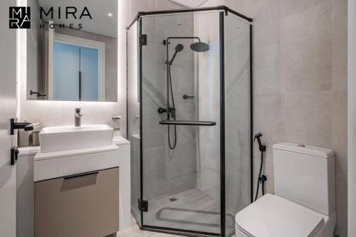 a bathroom with a shower and a toilet and a sink at Mira Holiday Homes - Lovely 1 bedroom in Midtown in Dubai