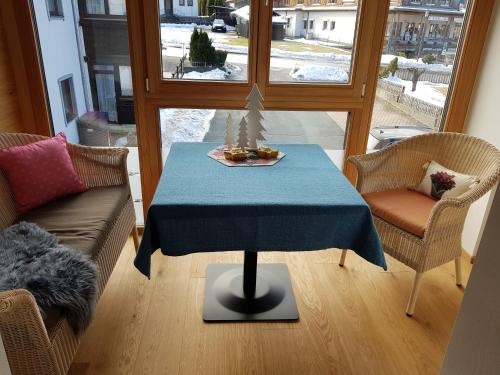 a living room with a table with a blue table cloth at Carinthia in Weissensee