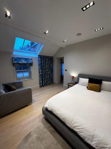 a bedroom with a large bed and a couch at The stables at the Grange in York