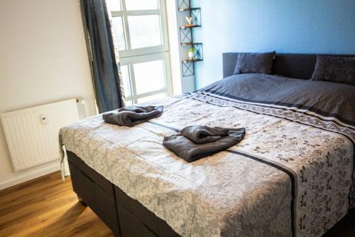 a bedroom with a bed with two towels on it at Fabrikdesign Düren in Düren - Eifel