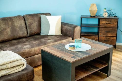 a living room with a couch and a coffee table at Fabrikdesign Düren in Düren - Eifel