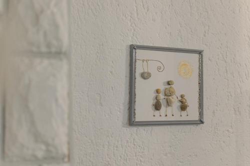 a picture of three figurines on a wall at Studio apartman Kamenčić in Osijek