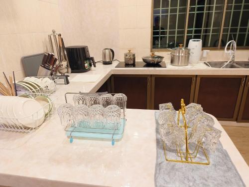 a kitchen with wine glasses on a counter at PandaHomestay28 in Skudai