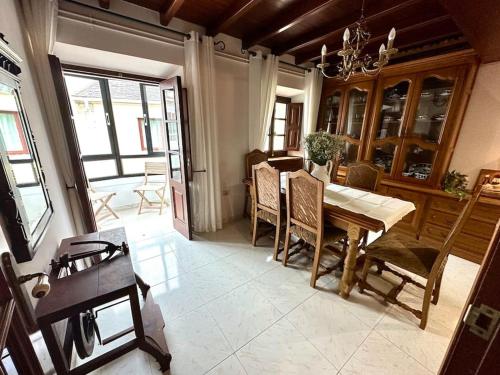 a dining room with a wooden table and chairs at A do Caseiro in O Barqueiro