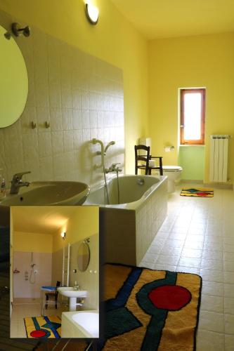 a large bathroom with a tub and a sink at Casa Re - B&B e Vino a Montabone in Montabone