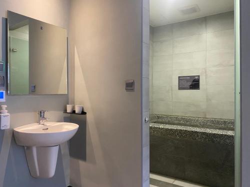 a bathroom with a sink and a shower at Prince Hotel in Jiaoxi
