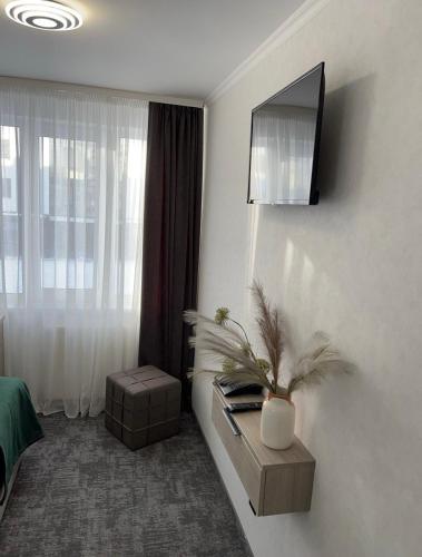 a hotel room with a tv on the wall at Prykarpattya in Ivano-Frankivsʼk