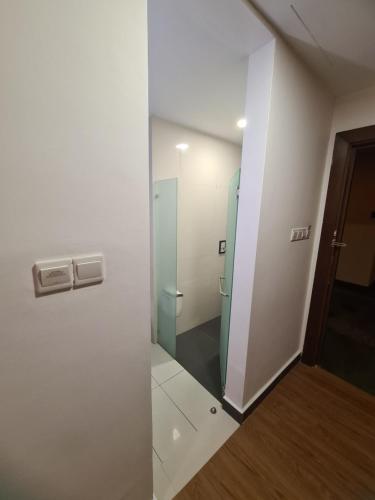 a bathroom with a glass door and a mirror at KL DUA SENTRAL Q59 Premium Stay in Kuala Lumpur