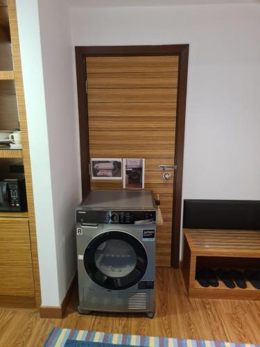 a washing machine in a room with a door at KL DUA SENTRAL Q59 Premium Stay in Kuala Lumpur