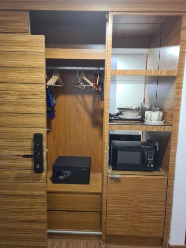 a kitchen with a cabinet with a microwave and a microwave at KL DUA SENTRAL Q59 Premium Stay in Kuala Lumpur