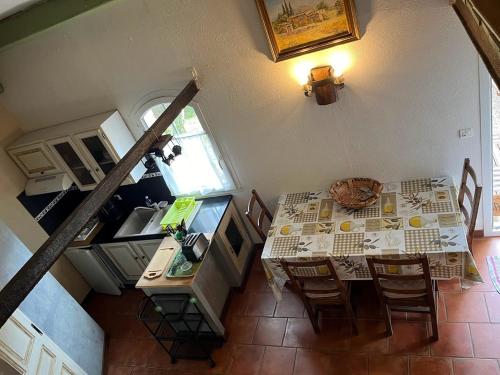an overhead view of a kitchen with a table and a dining room at Bastidon les Oliviers in Belgentier