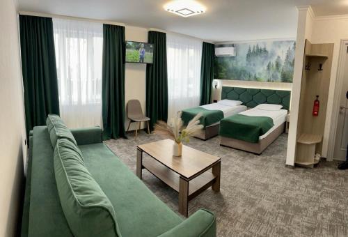 a hotel room with a couch and a bed at Prykarpattya in Ivano-Frankivsk