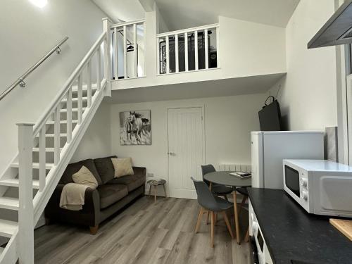 a living room with a couch and a table at Central Colwyn Bay F1 in Colwyn Bay