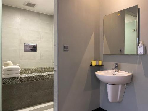 a bathroom with a sink and a mirror at Prince Hotel in Jiaoxi