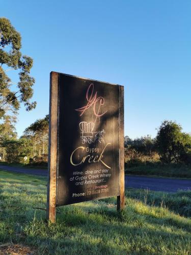 a sign for a golf course on a field at Gypsy Creek Retreat in Labertouche