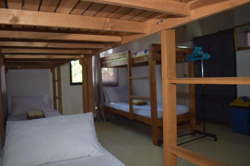 a bedroom with two bunk beds and a bed at Sealor Pension House in Puerto Princesa City