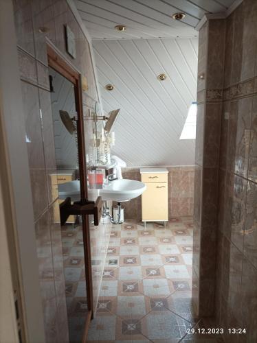 a bathroom with a sink and a mirror at Central Hotel in Schwetzingen