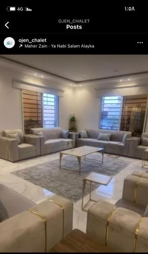 a living room with couches and a coffee table at شالية أوجن in Unayzah