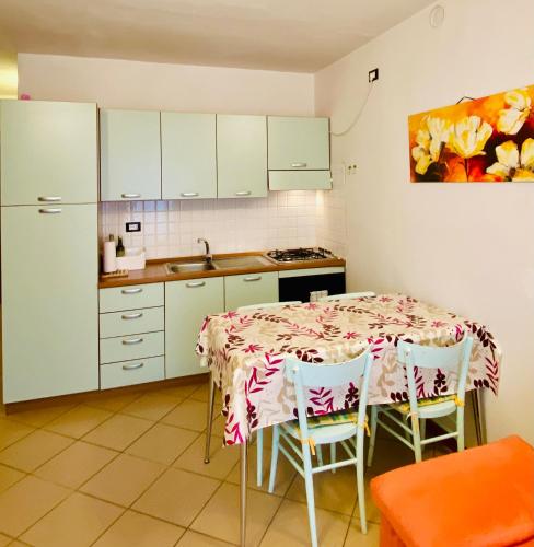 a kitchen with a table with chairs and a sink at Casa Giuliana in Teglio