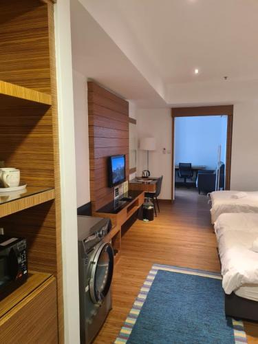 a hotel room with a bed and a living room at KL DUA SENTRAL Q59 Premium Stay in Kuala Lumpur