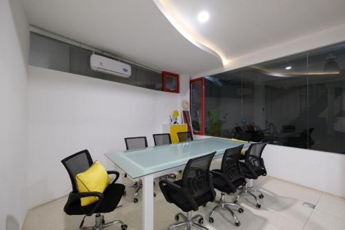 an office with a blue table and black chairs at S101 Hotels in Semarang
