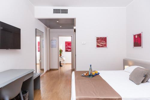 Un dormitorio con una cama con una bandeja de fruta. en Helios Hotel & Restaurant, en Monza