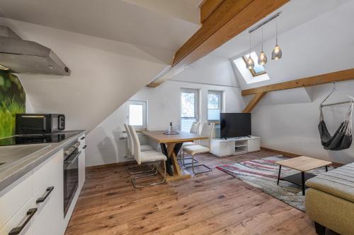 a kitchen and living room with a table and a couch at GRUBERS, Hotel Appartments Gastein in Bad Gastein