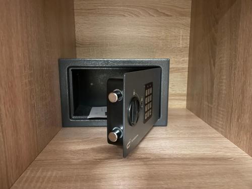 a safe with a door open on a wooden wall at Apartamenty Carpe Diem in Ustroń