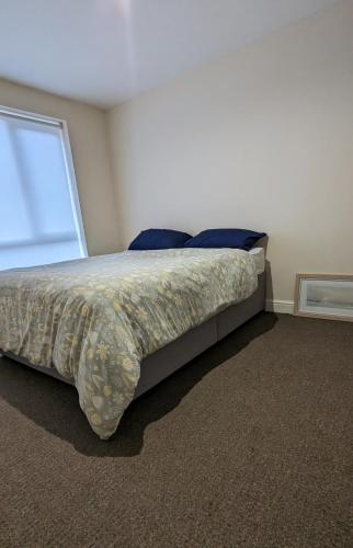 a bedroom with a large bed with a window at Private 1bedroom home in North Tyneside