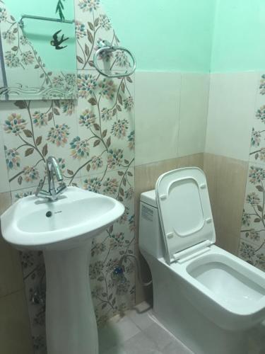 La salle de bains est pourvue d'un lavabo et de toilettes. dans l'établissement Little Heaven Restaurant & Guesthouse, à Deorāli