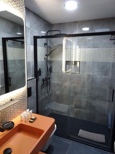 a bathroom with a shower and a sink at Lankarifa Apartment in Tarifa