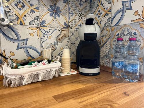 a bottle of water sitting on top of a wooden floor at Suite Lady Marian in Roccaraso