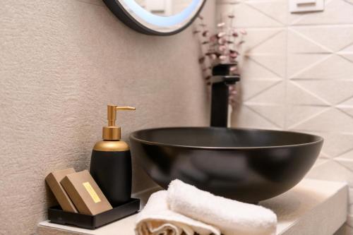 a black bowl sink on a counter in a bathroom at Enavlion Luxury Domes in Panayia