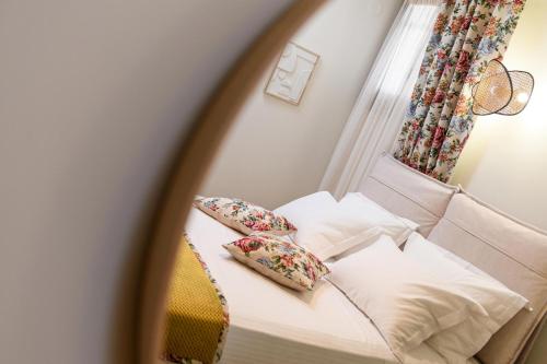 a reflection of a bed with pillows in a mirror at Enavlion Luxury Domes in Panayia
