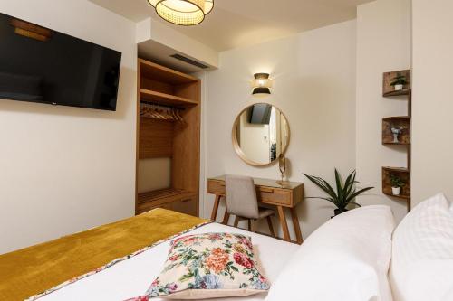 a bedroom with a bed and a mirror and a desk at Enavlion Luxury Domes in Panayia