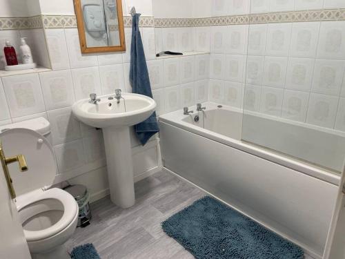 a bathroom with a sink and a toilet and a bath tub at Barleyfields. Entire House 4 beds 2 baths in Audley