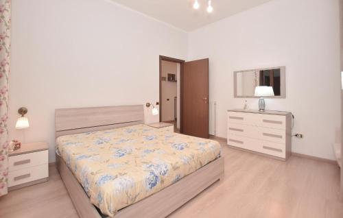 a bedroom with a bed and a dresser and a window at Awesome Apartment In Tuscania With Kitchenette in Tuscania