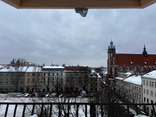 a view of a city with snow covered buildings at High Standard Room in Jewish District, Apartment Shared with Host in Krakow