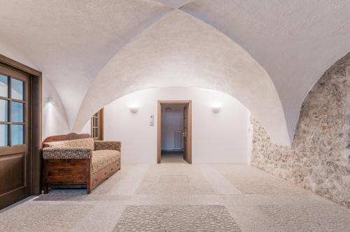 a hallway with an arched ceiling and a door at Sartori Mountain Apartment in Pinzolo