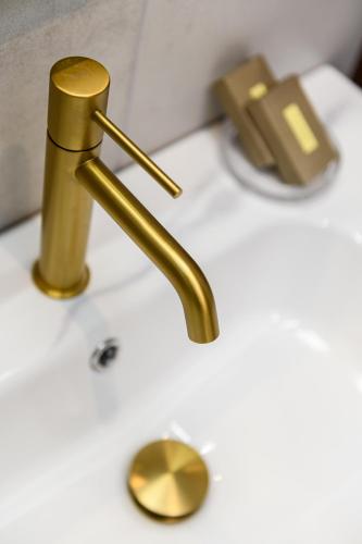 a bathroom sink with a gold faucet on it at Enavlion Luxury Domes in Panayia