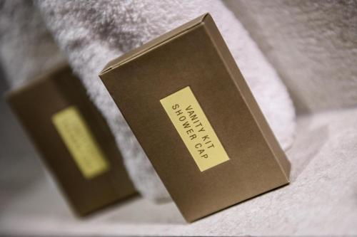 a book with a label on it sitting on a bed at Enavlion Luxury Domes in Panayia